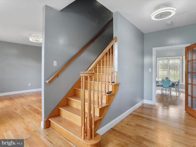 stairs featuring hardwood / wood-style flooring