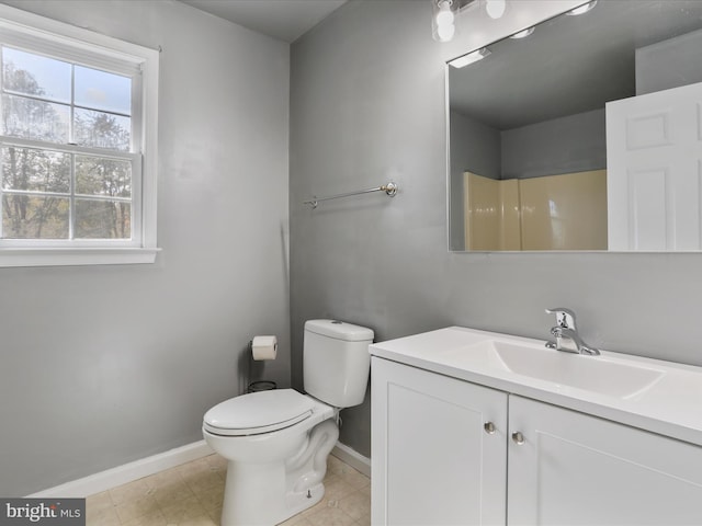 bathroom featuring toilet, vanity, a shower, and tile patterned floors