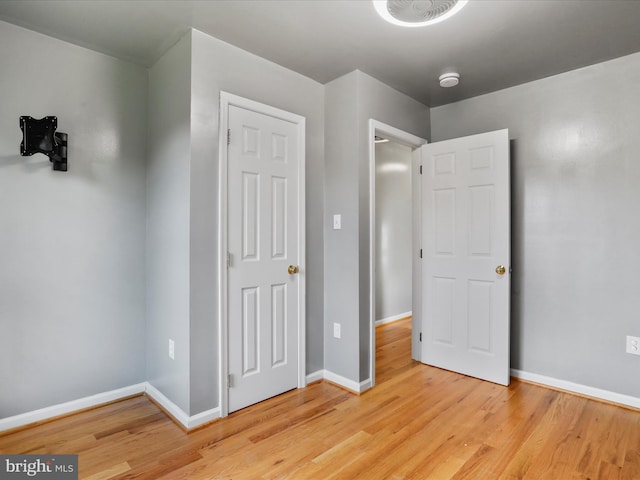 unfurnished bedroom with light wood-type flooring