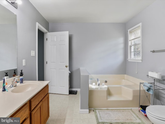 bathroom featuring toilet, vanity, and a bathtub