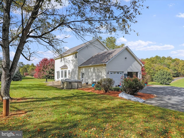 view of home's exterior featuring a garage and a yard