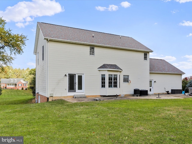 back of property with central AC unit, a yard, french doors, and a patio