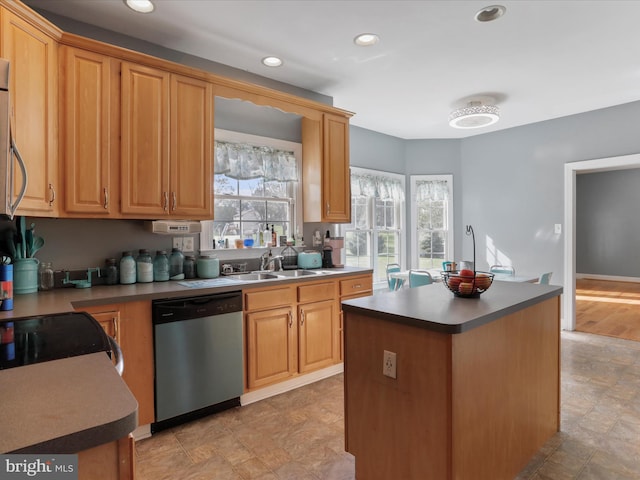 kitchen featuring a kitchen island, stainless steel dishwasher, and sink