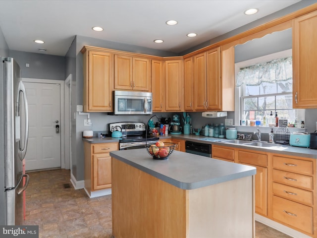 kitchen featuring light brown cabinetry, sink, a center island, and stainless steel appliances