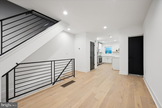 hall with light wood-type flooring