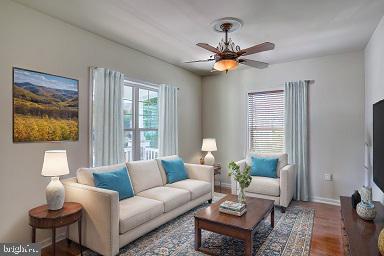 living room with hardwood / wood-style floors and ceiling fan