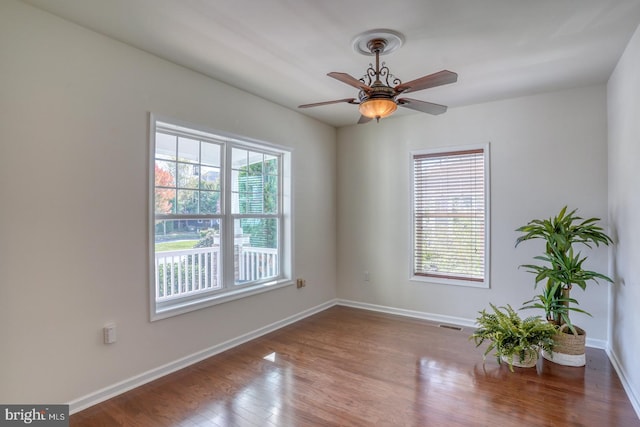 spare room with ceiling fan and wood-type flooring