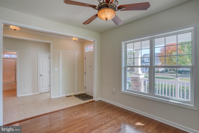 foyer with light hardwood / wood-style floors and ceiling fan