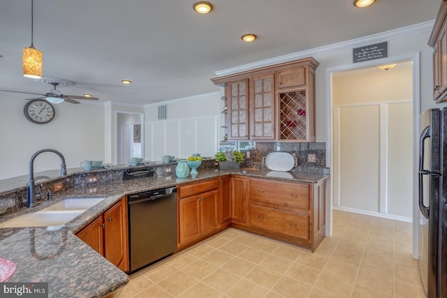 kitchen featuring black dishwasher, hanging light fixtures, ornamental molding, sink, and stainless steel fridge