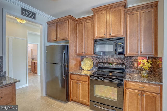 kitchen featuring decorative backsplash, dark stone counters, ornamental molding, black appliances, and light tile patterned flooring