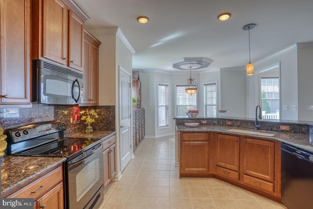 kitchen with black appliances, sink, decorative light fixtures, dark stone counters, and ornamental molding