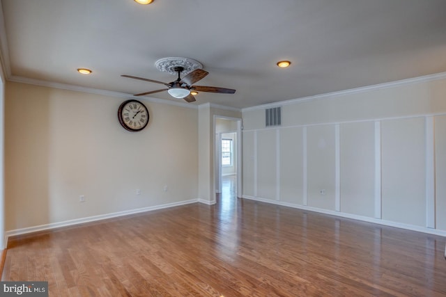 unfurnished room with ceiling fan, ornamental molding, and hardwood / wood-style floors