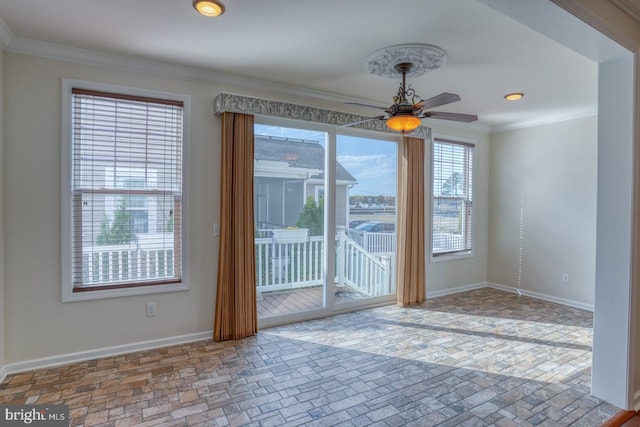 interior space with crown molding and ceiling fan