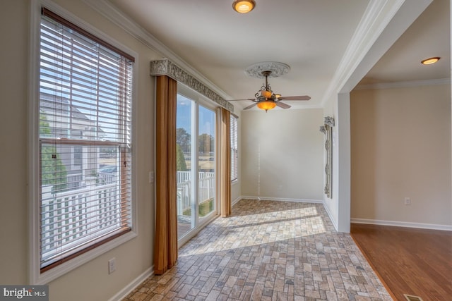 interior space with ornamental molding, hardwood / wood-style floors, and ceiling fan