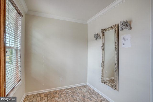 empty room featuring ornamental molding and a healthy amount of sunlight