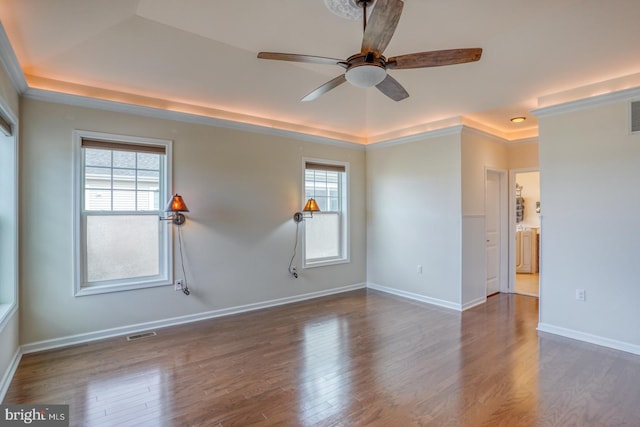 empty room with crown molding, ceiling fan, and dark hardwood / wood-style flooring