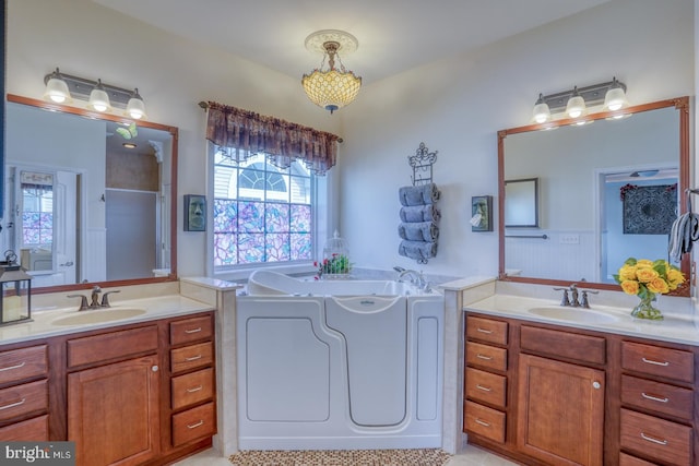 bathroom featuring vanity and a tub