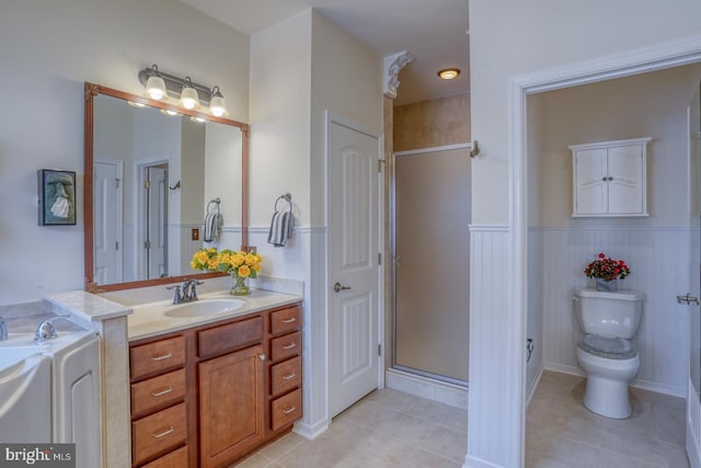 bathroom with toilet, an enclosed shower, vanity, and tile patterned flooring