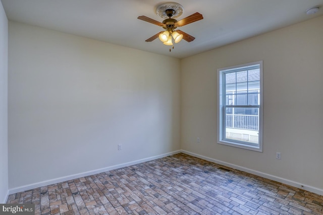 unfurnished room with ceiling fan