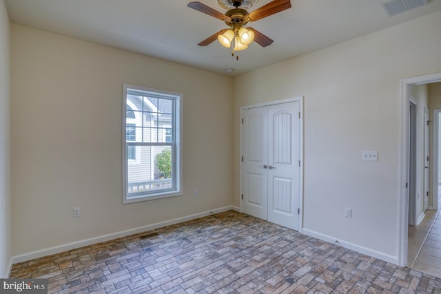 unfurnished room with ceiling fan