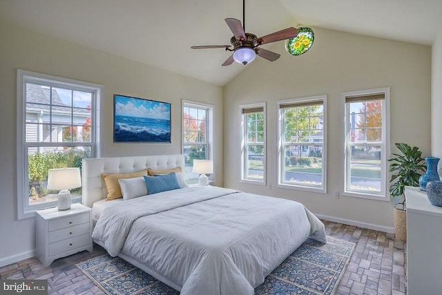 bedroom with ceiling fan, lofted ceiling, and multiple windows