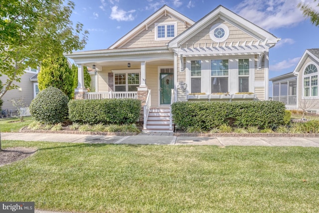 view of front of house with a porch and a front lawn