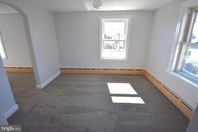 carpeted spare room with baseboard heating