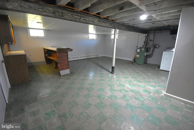 basement with washer / dryer, baseboard heating, and a wealth of natural light