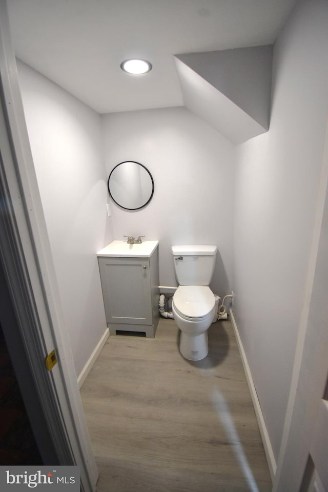 bathroom featuring vanity, toilet, and hardwood / wood-style flooring