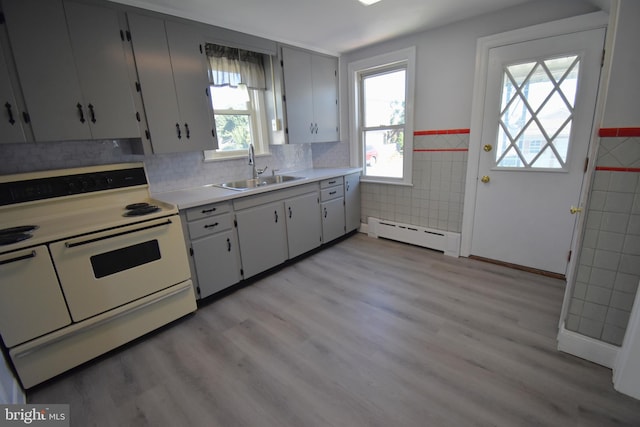 kitchen featuring white range with electric stovetop, a baseboard heating unit, sink, and light wood-type flooring