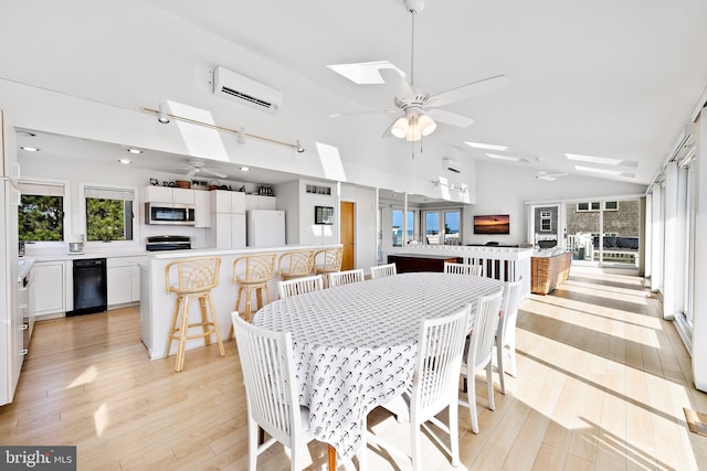 1039 Long Beach Blvd, Long Beach Township, NJ 08008 - dining room with a skylight, ceiling fan, a wall mounted AC, light wood-style floors, and high vaulted ceiling