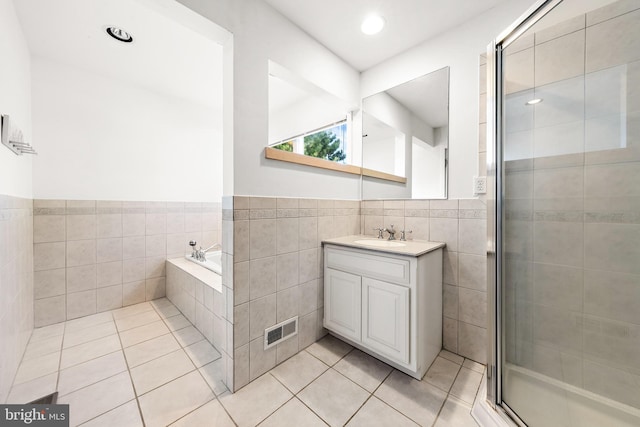 1039 Long Beach Blvd, Long Beach Township, NJ 08008 - full bathroom with tile patterned floors, vanity, tile walls, a stall shower, and a bath