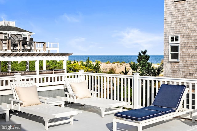 balcony featuring a water view and a pergola