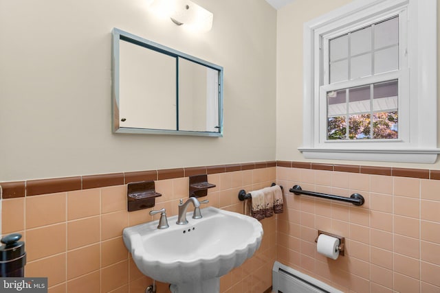 bathroom with sink and tile walls