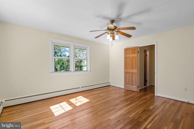 empty room with wood-type flooring, a baseboard radiator, and ceiling fan