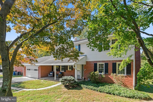 view of front facade with covered porch, a front yard, and a garage