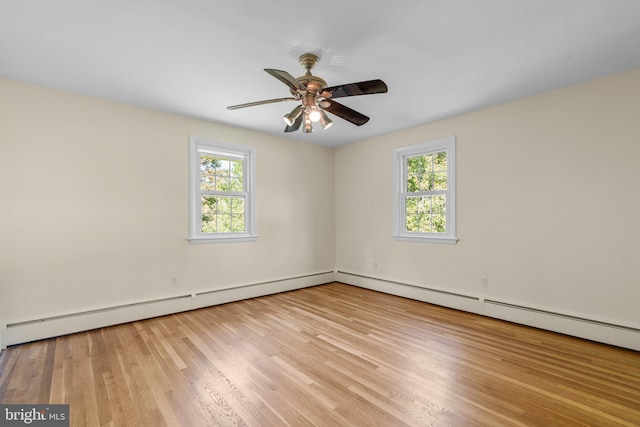 unfurnished room featuring light hardwood / wood-style floors, a baseboard radiator, plenty of natural light, and ceiling fan