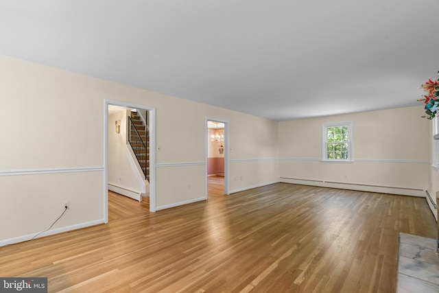 spare room featuring light hardwood / wood-style flooring and baseboard heating