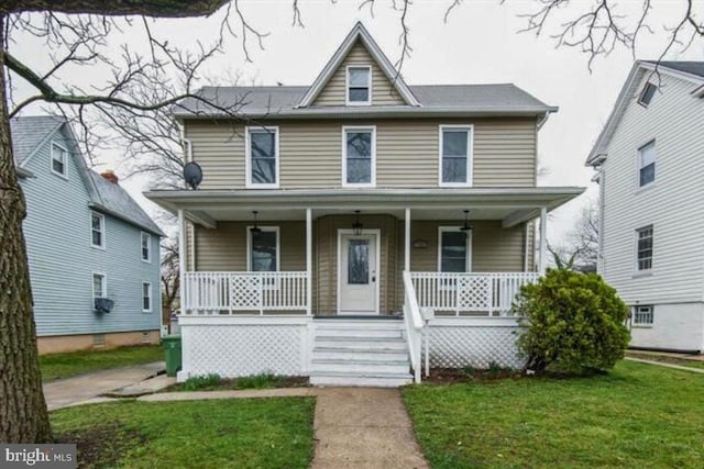 view of front of house with a porch and a front lawn