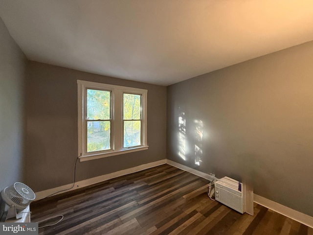 unfurnished room with dark hardwood / wood-style floors