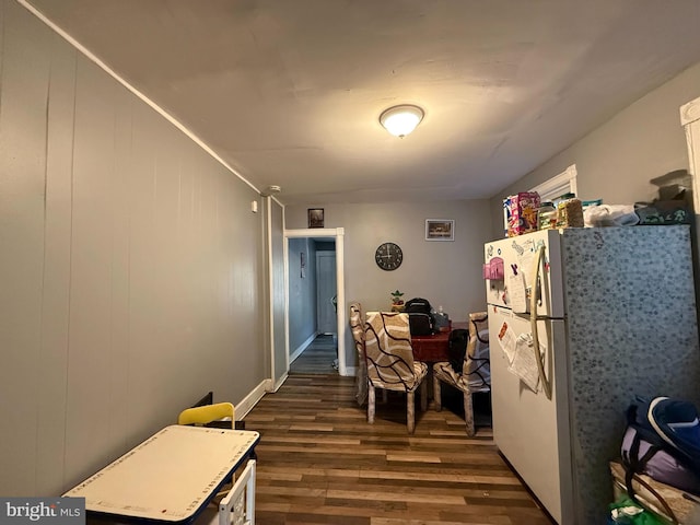 kitchen featuring dark hardwood / wood-style floors and white fridge