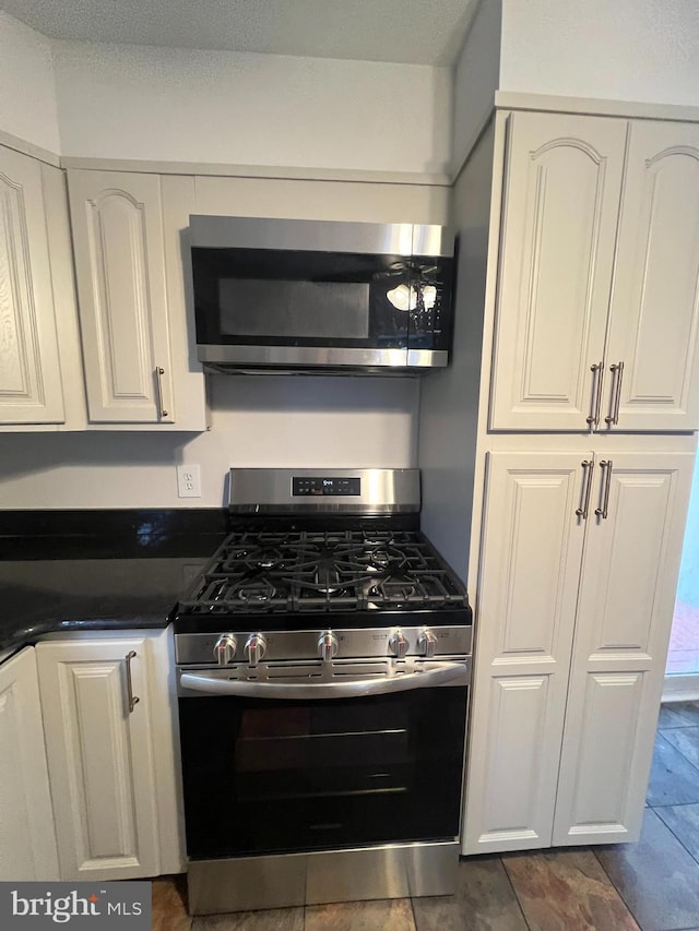 kitchen with stainless steel appliances and white cabinets