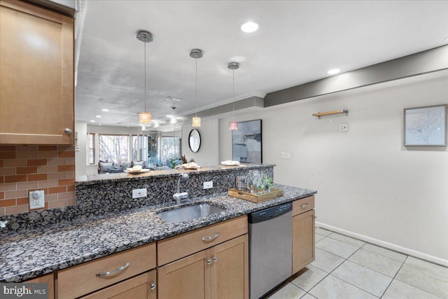 kitchen featuring tasteful backsplash, sink, hanging light fixtures, dark stone counters, and stainless steel dishwasher