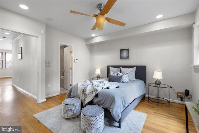 bedroom with ensuite bath, crown molding, hardwood / wood-style flooring, and ceiling fan