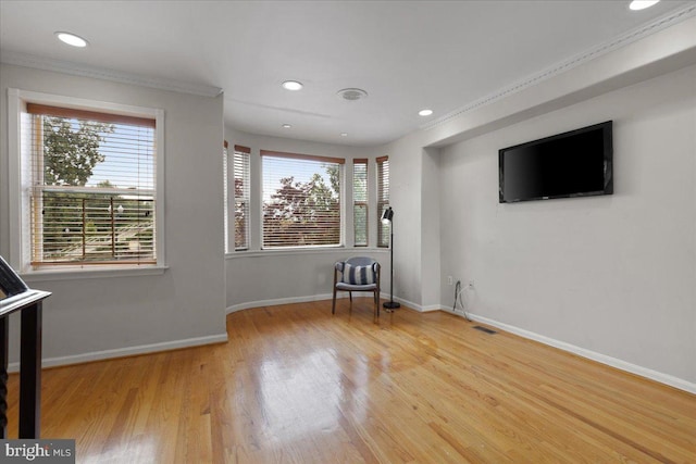 interior space featuring ornamental molding and hardwood / wood-style flooring