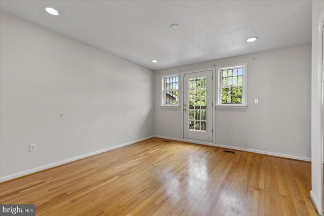 spare room featuring light wood-type flooring