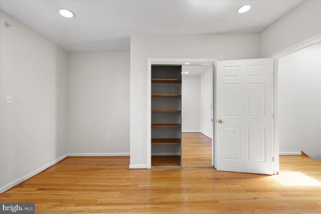 unfurnished bedroom featuring a closet and light hardwood / wood-style floors