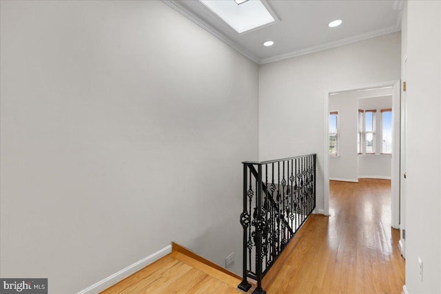 corridor with crown molding and wood-type flooring