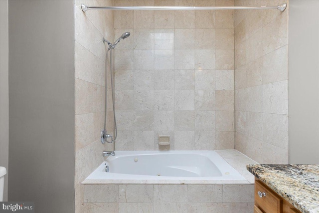 bathroom with vanity and tiled shower / bath