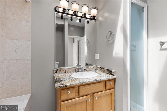 bathroom featuring vanity and toilet